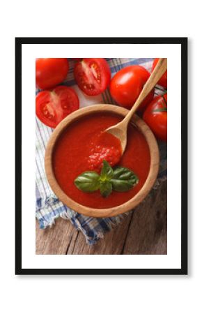Fresh tomato sauce in a wooden bowl closeup. vertical top view  