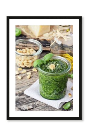 Basil pesto on a rustic wooden table.Selective focus 