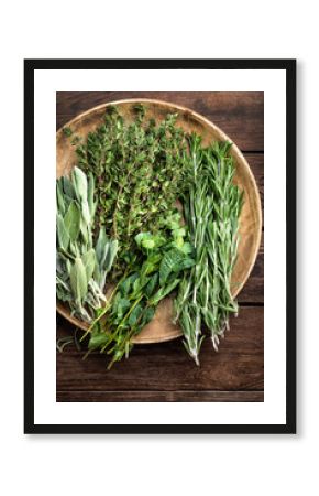 various fresh herbs, rosemary, thyme, mint and sage on wooden background