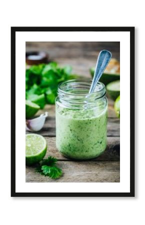 green salad dressing with avocado, lime and cilantro in a glass jar