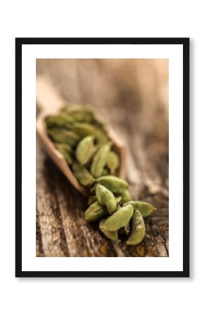 Cardamom seasoning in a wooden spoon close up.