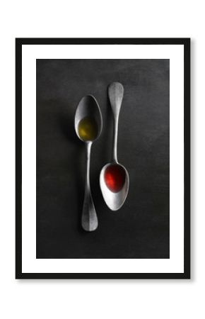 Overhead view of oil and vinegar in spoons