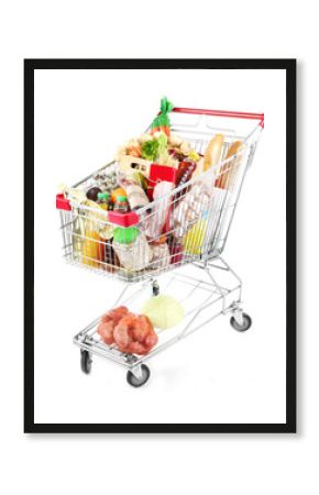Shopping cart full with various groceries isolated on white