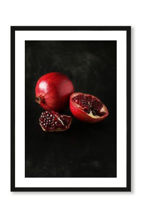 Delicious pomegranate fruit on black background