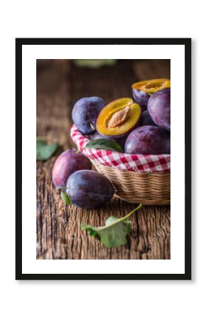 Plums. Fresh juicy plums in a bowl on a wooden or concrete board.