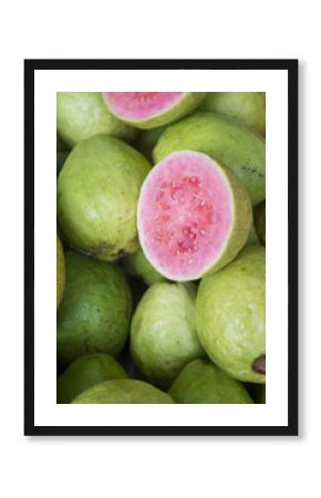Fresh ripe guava fruit cut open to display the pink flesh at a farmers market in Rio de Janeiro, Brazil