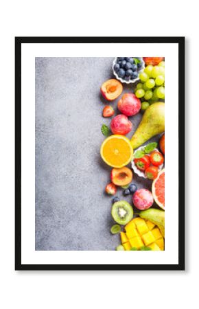 Fresh assorted fruits and berries on light gray background. Colorful clean and healthy eating. Detox food. Copy space. Top view.