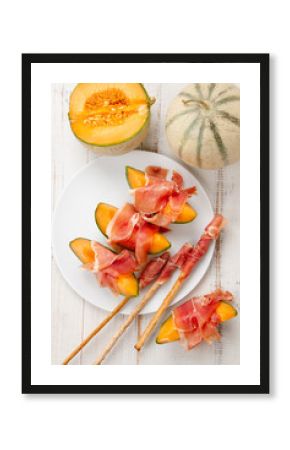 Melon with prosciutto and grissini
