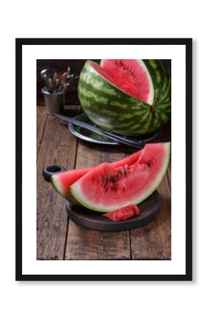 Sliced ripe watermelon on brown wooden table.