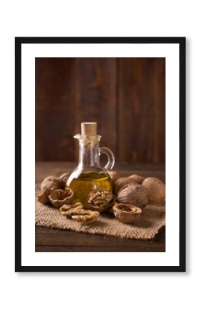Walnut oil and nuts on wooden table