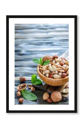 Assorted nuts in a wooden bowl.