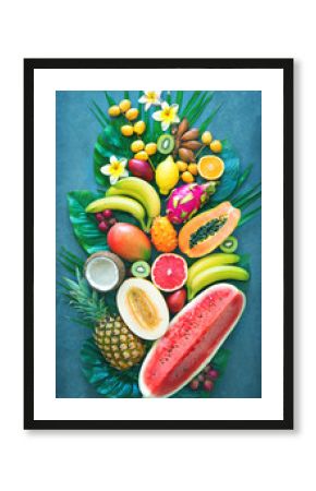 Assortment of tropical fruits with palm leaves and exotic flowers