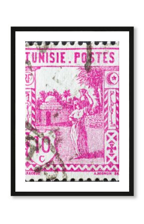 Tunisia - circa 1926: a postage stamp from Tunisia, showing a woman carrying water