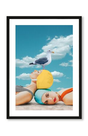 Beautiful young girls in swimming cap and swimsuits lying on beach with seagull against blue sky background. Contemporary art. Concept of summer, vacation, relaxation. Retro style. Creative design.