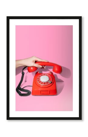 Woman hand picking up the phone.  Answering concept minimal