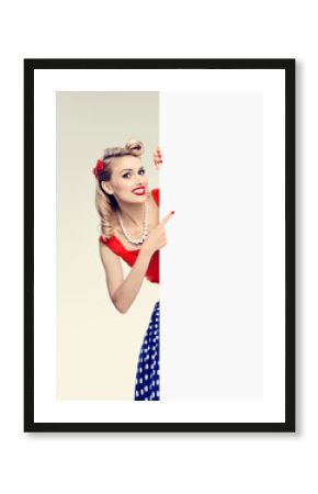 woman in pin-up style dress, showing blank signboard