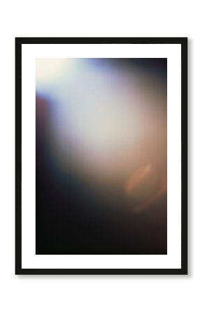 Designed film texture background with heavy grain, dust and a light leak Real Lens Flare Shot in Studio over Black Background.