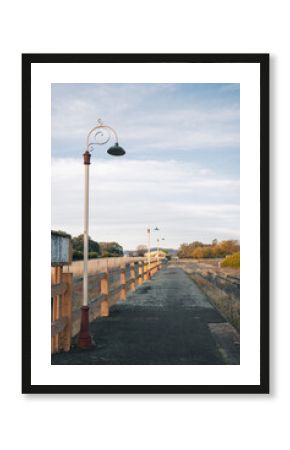 Row of antique lamp posts along platform of abandoned railway station